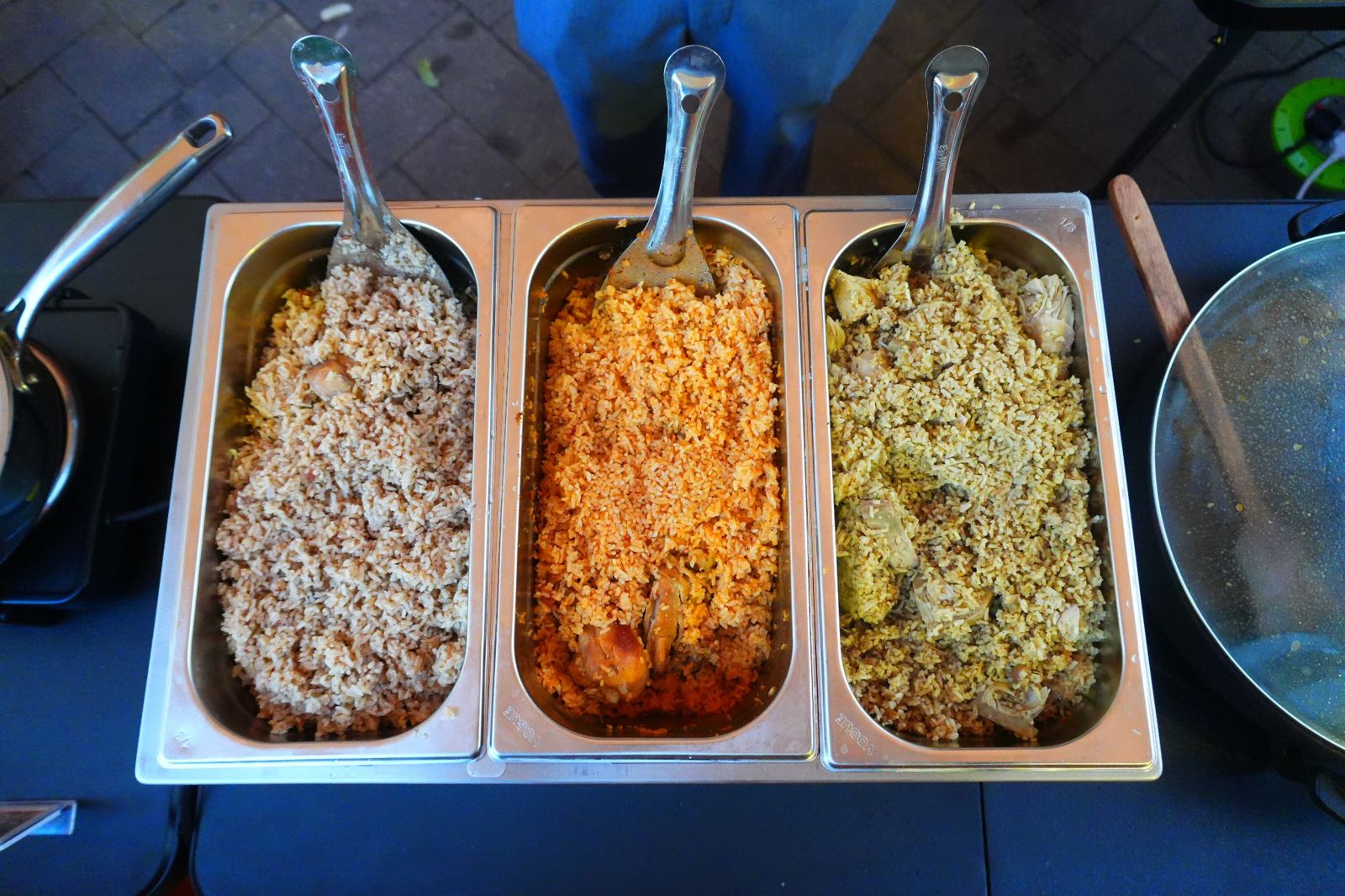 Three trays of biryani at the stall